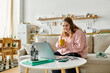 © Bliss - Young confident woman with Down syndrome enjoying cozy moments at home with a warm drink
