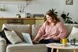 © Bliss - Young woman with Down syndrome enjoys a cozy moment at home while using her laptop