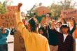 © Carlo Prearo - Group of activists protesting for climate action, raising fists and holding signs for environmental justice