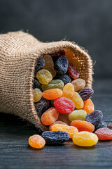 Poster - Dried fruits spilling from a burlap sack onto wooden surface, rustic country-style photography,