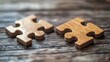 © Mykhailo - Two Wooden Puzzle Pieces on Rustic Wooden Table Surface
