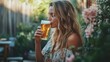 © Roman - Young caucasian female enjoying a refreshing beer in a floral garden setting