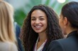 © yang - Networking businesswomen smiling and talking at professional conference