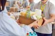© Studio Romantic - Food box giving to help, caring volunteer group working in charitable food foundation, make donation to needy, charity, separating donations stuff, food bank stocks, basic need provisions, free meal