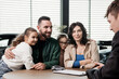 © wedmoments.stock - A family in the background of a car in a modern car dealership makes a deal to buy a new car with the dealer. The concept of buying or leasing a new car.