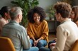 © Vadym - Diverse group people sitting in circle, group therapy session. Smiling black woman in center with others. Mental health care, support, recovery, discussion, communication in rehab.