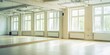 © Sangad - Spacious dance or fitness studio featuring large mirrors and windows.