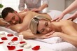 © New Africa - Couple receiving relaxing massage in spa salon, selective focus