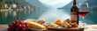 © Vadym - Panoramic view Lake Como. Italian landscape, cheese, wine, bread selection on wooden table. Red wine in glass, grapes. Gastronomy, vacation, travel, relaxation, culinary. Tranquil water, scenic views.