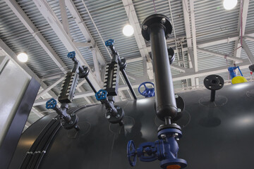 Aufkleber - Large industrial heating boiler. Black pipe with blue valve on it. Pipe connected to large tank. Industrial concept background
