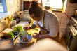 © Marko Geber - Male asian chef preparing a traditional food dish in a restaurant kitchen