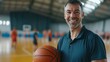 © IMAGINIAC - Smiling Man in Blue Polo Shirt Holding Basketball in Indoor Court Setting