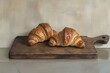 © masud - Two Golden Croissants on a Rustic Wooden Board