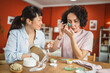 © Miljan Živković - female friends share skincare moment use eye patches relax together
