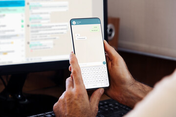 man showing a phone in his hand and chatting app on the screen of smartphone. communication technolo
