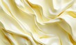 © Azril - Creamy yellow fabric folds texture background for design