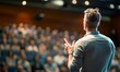 © NovaVision - A speaker engages a large audience during a presentation at a corporate conference event.