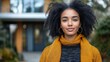 © BlackBird Studio - Confident Young Woman with Curly Hair in Cozy Autumn Outfit Outdoors