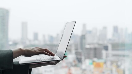 Poster - Woman using a laptop with city background