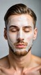 © Chenda - young handsome man thick facial mask clean background cosmetic
