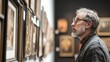 © sambath - A curator in a gallery examining a piece of artwork, ensuring it is preserved as part of an art conservation effort.