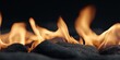 © xbzz - Warm Orange Flames Dancing Above Black Lava Rocks, Cozy Fireplace Ambiance