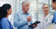 © peopleimages.com - Doctors, group and tablet for hospital management with discussion for funding, planning and review. Director, leader and team with surgeon, nurse and feedback with application at wellness clinic