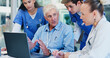 © WestLey/peopleimages.com - Man, doctors and laptop with group at hospital with discussion for funding, management and review. People, leader and team with surgeon, problem solving and feedback with computer at wellness clinic