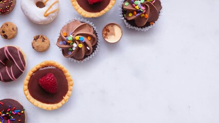 Leinwandbilder - Assortment of sweet desserts. Top down view, stop motion timelapse video on a white marble background.