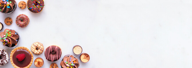 Leinwandbilder - Dessert corner border with an assortment of sweets. Top view on a white stone banner background with copy space.