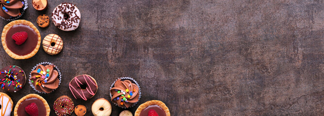 Leinwandbilder - Dessert corner border with various sweets. Top view on a dark stone banner background with copy space.