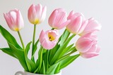 A vase of pink tulips sits on a white table. The flowers are in full bloom and are arranged in a way that makes them look like they are standing tall. The vase is the only object in the scene
