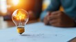 © CreativeSeven  - A creative representation of innovation featuring a glowing lightbulb symbolizing ideas and inspiration against a blurred background.