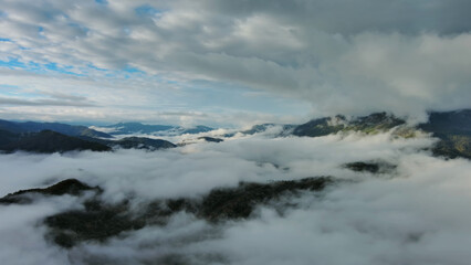 Wall Mural - aerial view of clouds and mountains at sunrise