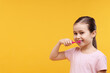 © New Africa - Cute girl brushing her teeth on orange background, space for text