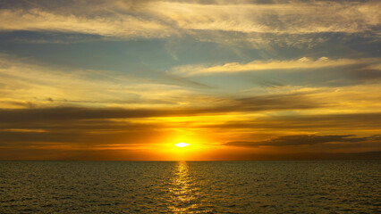 Wall Mural - stunning sunset over calm ocean waters