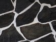 © Faizal - The walls of the house using stone are painted with black and white lines