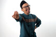 © Jamaludinyusup - Asian Muslim man making a 'come here' beckoning gesture, inviting someone with an engaging expression. Isolated on a white background