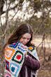© Austockphoto - Woman standing outside with jumper and blanket in winter
