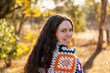© Austockphoto - Female adult outside in winter with crochet blanket around shoulders