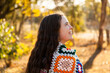 © Austockphoto - Female adult outside in winter with crochet blanket around shoulders