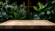 © Kang - Rustic Wooden Table in Cozy Cafe with Lush Tropical Greenery
