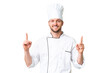 © luismolinero - Young caucasian chef over isolated chroma key background pointing up a great idea