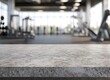 © Tanish - A light gray marble countertop in the foreground with an out-of-focus gym interior background