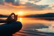 © singgih - Woman Meditating at Sunset Over Lake Surface with Warm Sky Reflection