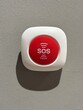 © Anna - Bright red SOS button mounted on a plain wall signifies a quick way to call for help in emergencies, observed in Valencia, Spain, on March 29, 2025