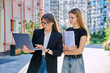 © Valerii Honcharuk - Female teacher talking to teenage student girl, outdoor, educational building background