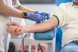 © LaMorenita - Anonymous hands of a nurse inserts the needle of the probe to her voluntary patient to start donating blood. It is the blood bank of a hospital for health care.