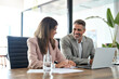 © insta_photos - Executive leaders managers using laptop computer technology discussing digital project together at corporate meeting. Two successful happy professional business partners in suits working in office.
