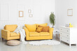© Pixel-Shot - Interior of stylish living room with cozy yellow sofa, armchair and chest of drawers